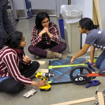 ATHack participants Ananya Nandy, Vyshnavi Vennelakanti, and Kanika Gakhar collaborate on their technology. 