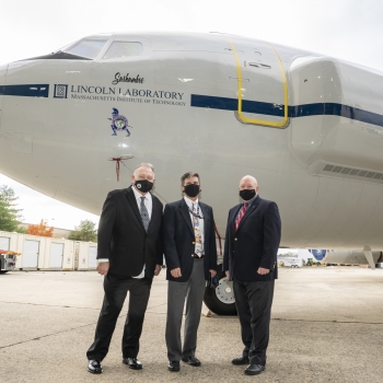 Dennis Hamel, chief mechanic, left, and Robert Maynard, chief pilot, right, are congratulated on their many years of service to N404PA by Scott Anderson, Assistant Director for Operations, Lincoln Laboratory. Photo: Glen Cooper