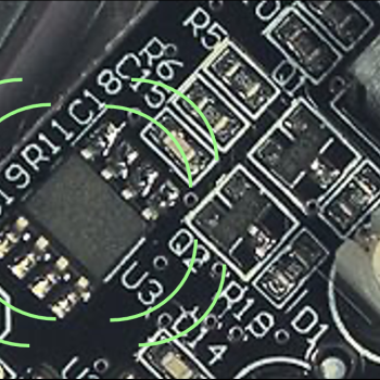 A close up image of a circuit board with 8 green lines emanating from the integrated circuit.