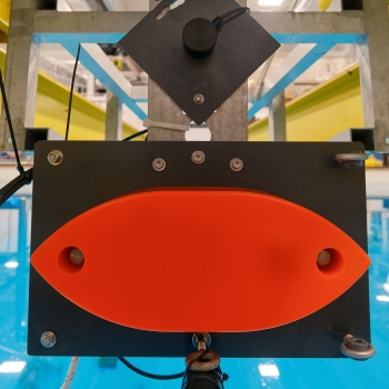 Three echosounders are lowered into an engineering test tank at the University of New Hampshire.