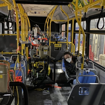 Laboratory staff member Meghan Ramsey is shown on an NYC subway car wearing a mask. 