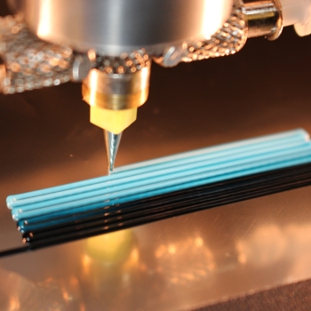 a 3D-printer nozzle extrudes ink 