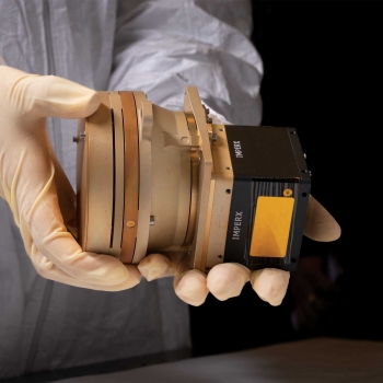 Photo of hands holding the prototype of the Chrisp Compact VNIR/SWIR Imaging Spectrometer.