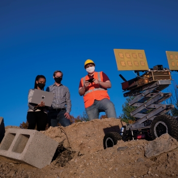 Photo of the MURMUR sensor integrated on an unmanned ground vehicle. Operators behind mobile vehicle remotely control the system.