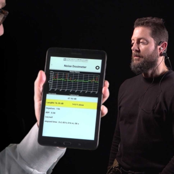 Photo of person wearing MNOISE microphones in ear and on body. User interface shows noise dosimeter levels.