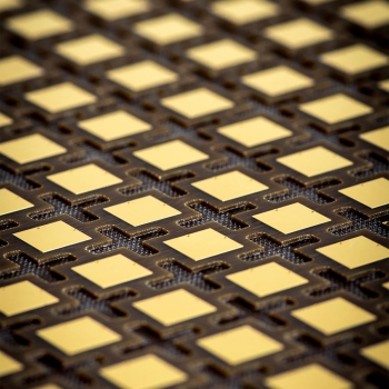 Photo of the lower printed circuit board for a lightweight antenna array panel for a space-based radar. The cutouts visible between the elements reduce the panel’s weight.
