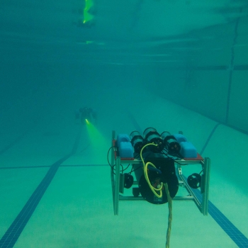 Underwater photo of Lincoln Laboratory's undersea communications technology and diver.