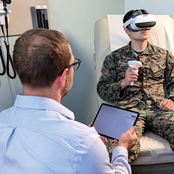 Photo of an administrator monitoring neurocognitive tests being completed by a subject using the MINDSCAPE VR headset.