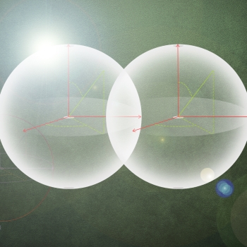 An illustration shows two orbs overlapping, representing coupling between artificial atoms and photons. 