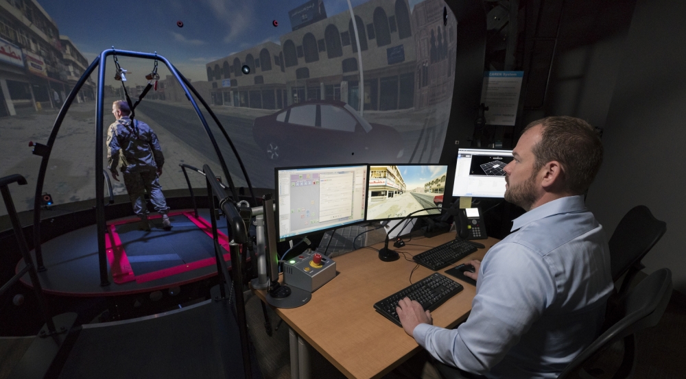 The STRIVE Center enables the assessment of cognitive and physiological performance as a person interacts with a virtual environment. The researcher above is monitoring the person's performance.