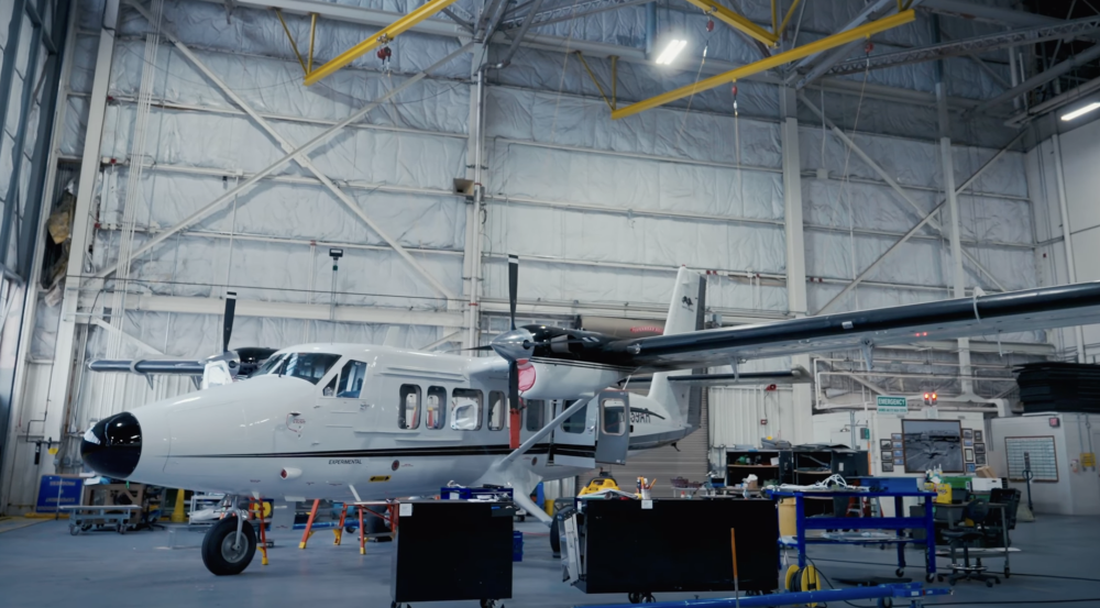 A modified aircraft sits inside a hangar.