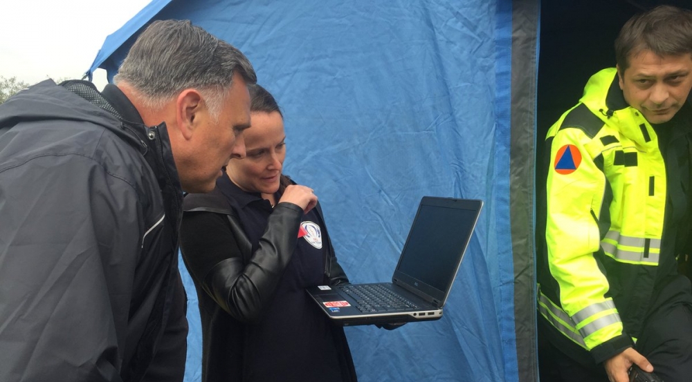 Stephanie Foster briefs DHS S&T Under Secretary (Acting) William Bryan on the Next-Generation Incident Command System (NICS) as he observes its use in water-rescue operations. Photo courtesy of DHS S&T