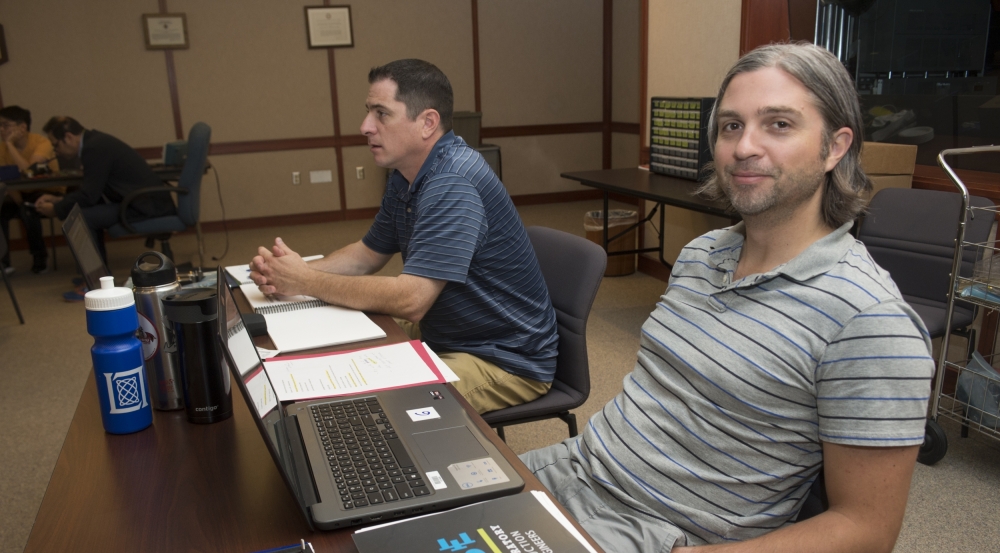 High school physics teachers Gary Campbell, left, and Scott Brunner, right, joined students in the classroom to learn about building small radar systems.