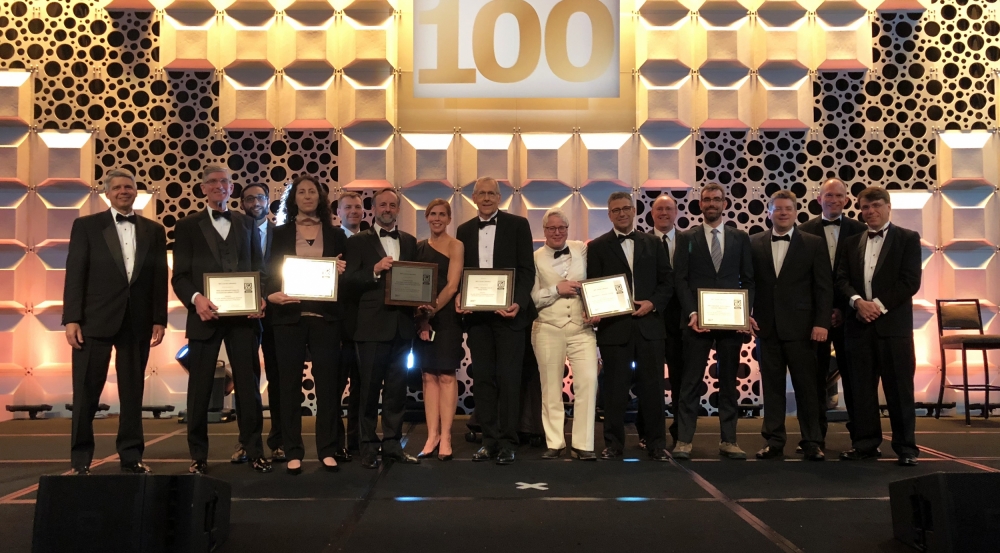 The principal researchers of Lincoln Laboratory's ten finalists for R&D 100 Awards are seen here with Lincoln Laboratory Director Eric Evans, far left. The principal researchers for the six winning technologies display their award plaques.