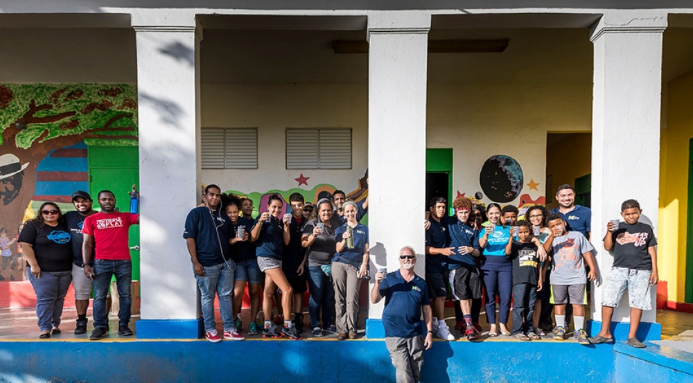 Local children join the team in raising their glasses of clean water after the tap-opening ceremony on 25 October. Photo: Lorenzo Moscia