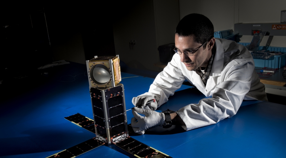 Mike DiLiberto leanes next to the MicroMAS-2A cubesat.