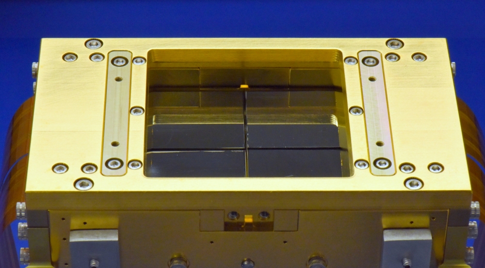 Shown above is a 150-millimeter wafer with four charge-coupled imaging device-41s, which are utilized in REXIS. The devices are shown in the center of the photo as four large squares in a row.