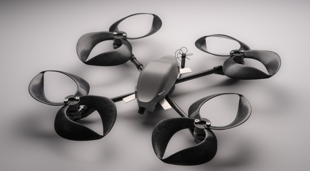 A small commercial drone outfitted with four toroidal propellers (each propeller looks like two loops, made of plastic).