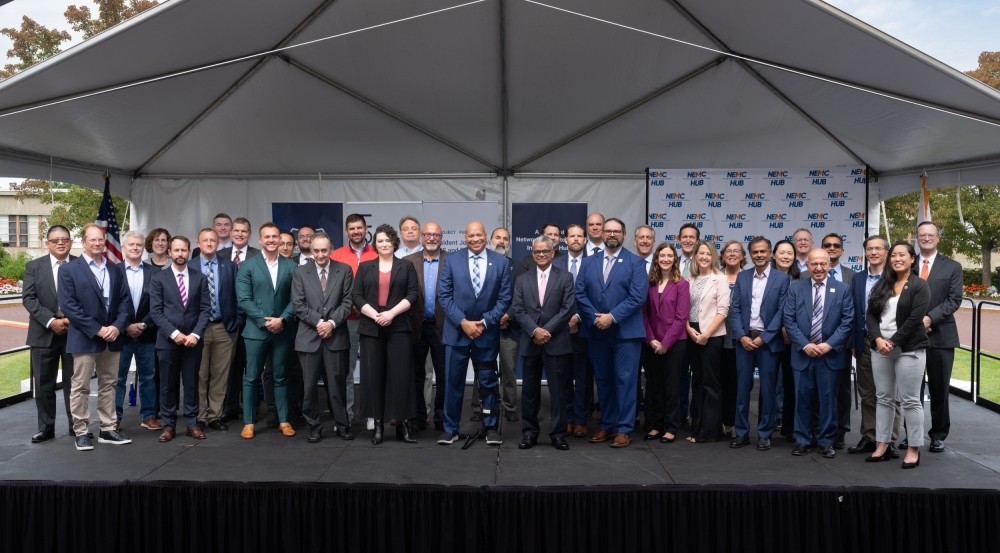 46 individuals pose for a group photo at the NECM Hub funding announcement event.
