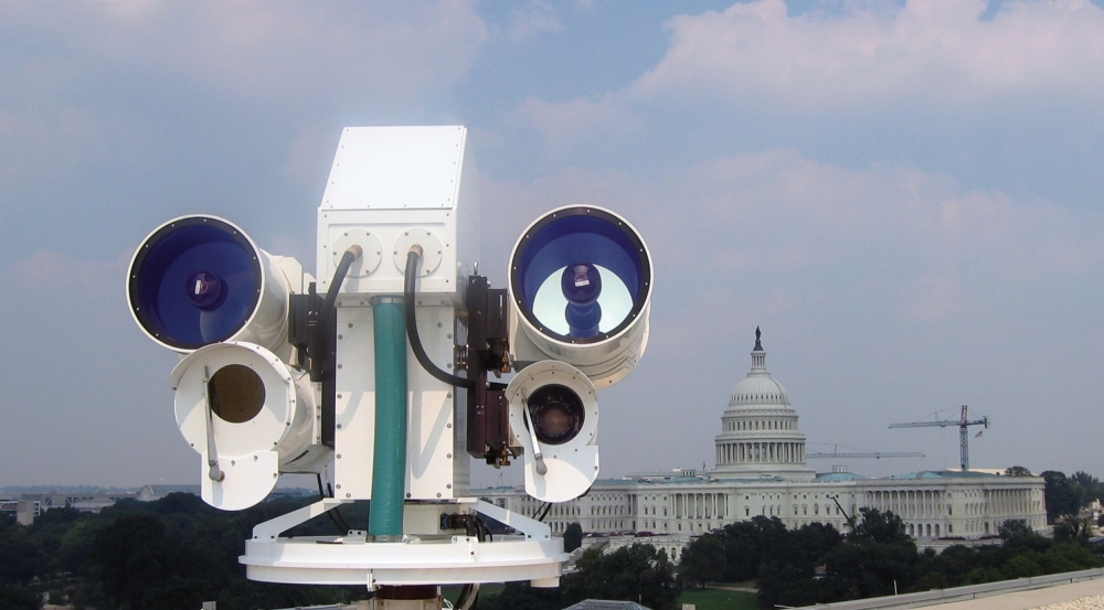 An optical system is installed on a rooftop with the Capitol building in view in the background.