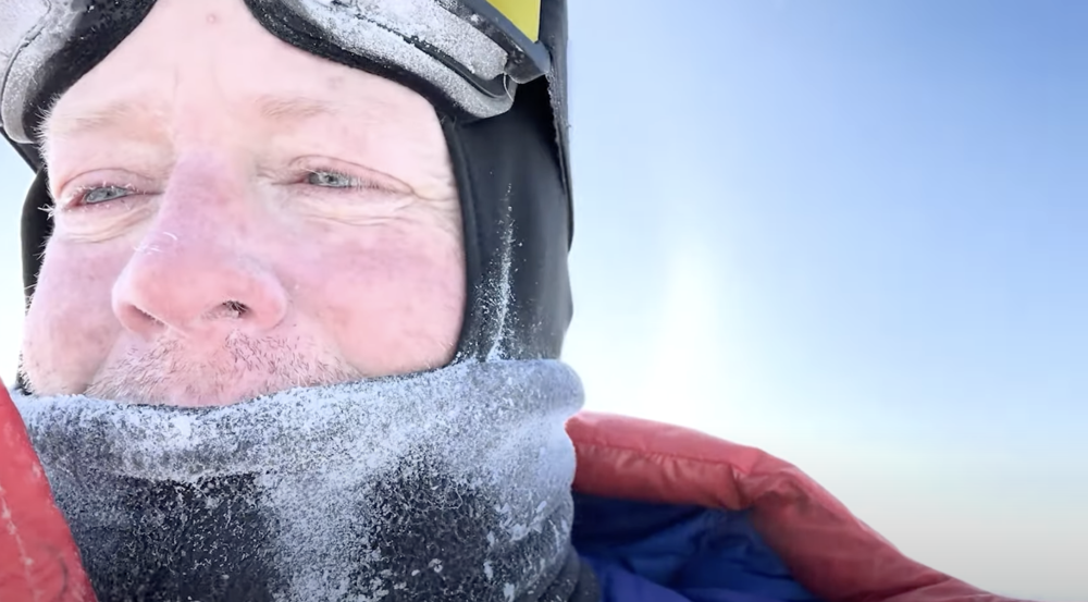 A man wears a balaclava encased in ice in the Arctic. 