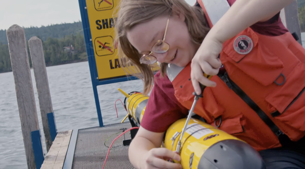 Ivy Mahncke positions a screwdriver over an underwater vehicle.