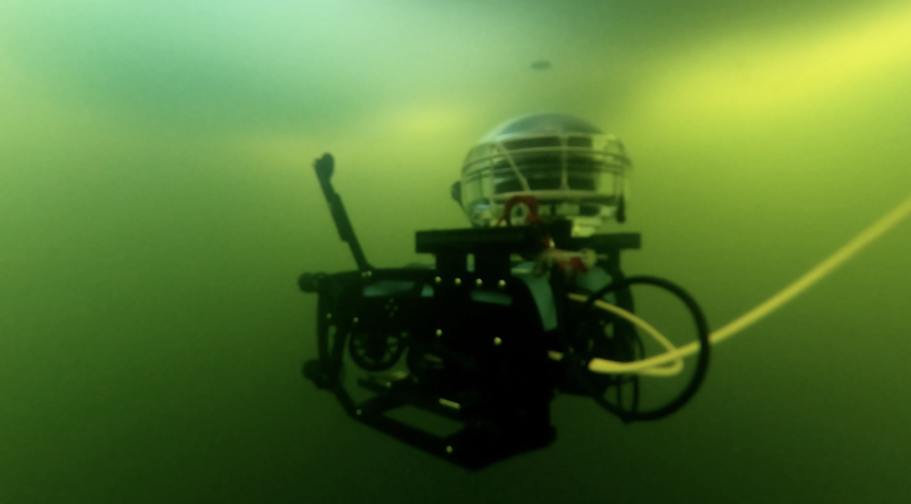 A remotely operated vehicle carrying a communications device drives underwater.