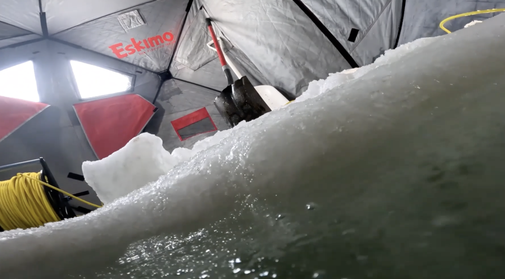 A remotely operated vehicle goes underwater through a hole made in sea ice. 
