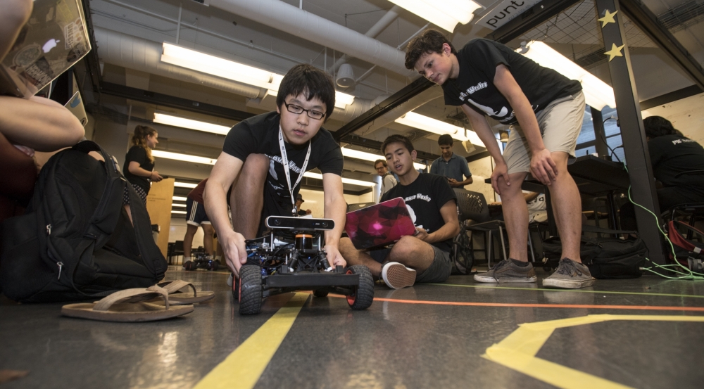 Students in the Beaver Works Summer Institute practice steering their self-programmed robotic racecars, a challenge that included using the robots' sensors, programmed to detect a lane marking. 