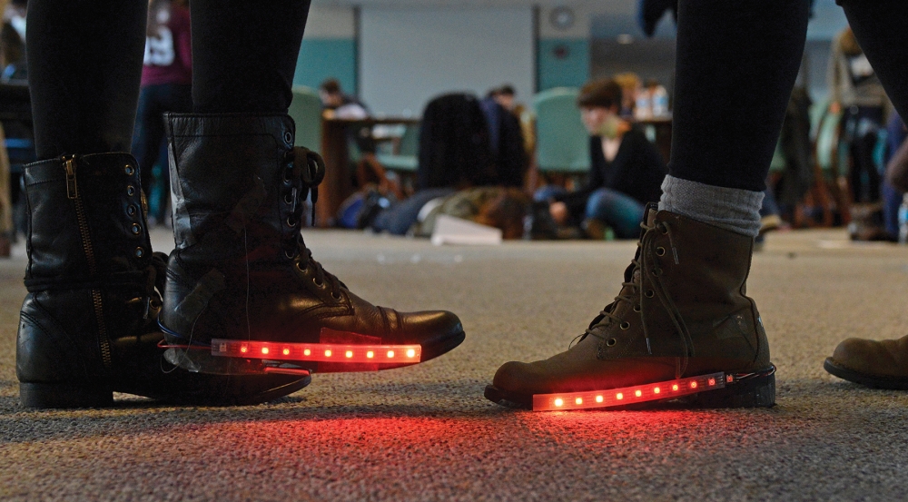 This course provides instructions for programming a wearable circuit board that measures resistance from a pressure-sensitive conductive sheet in the heel of the shoe. When resistance changes, red lights are triggered.