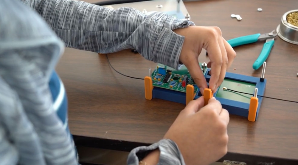 A student works on an electronics project.