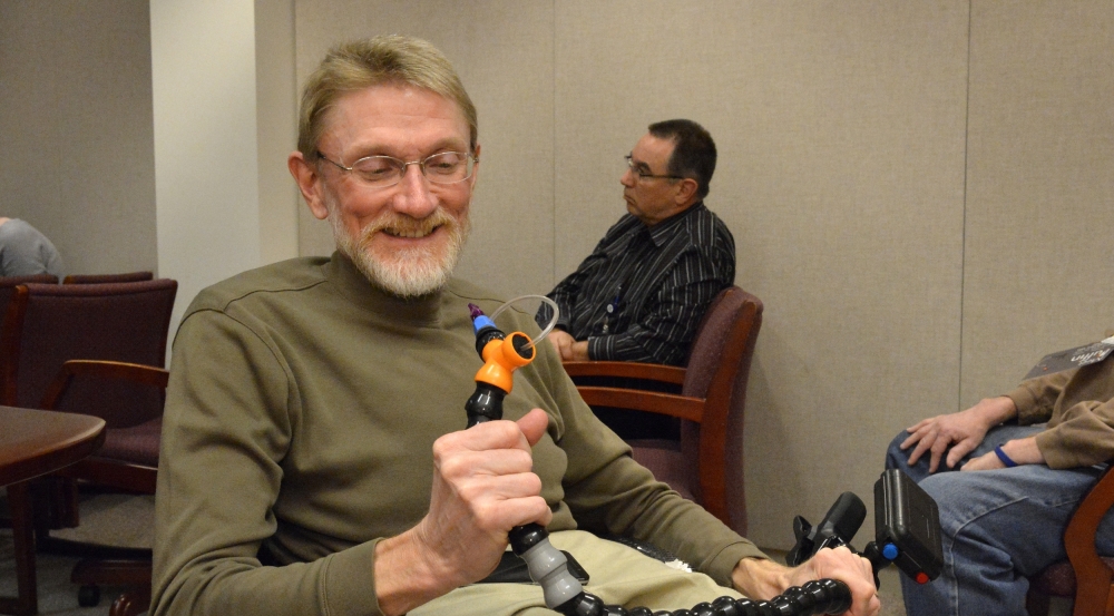 A LED committee member, Gary Brendel, helped organize a seminar for employees to learn more about the Puffin, a wireless sip-and-puff joystick controller designed by MIT students for a client with cerebral palsy.