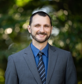 An outdoor portrait photograph of Vitaliy Gleyzer.
