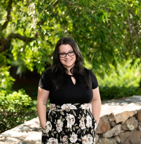 Photo of Corilee Nunes outside with trees in the backround.
