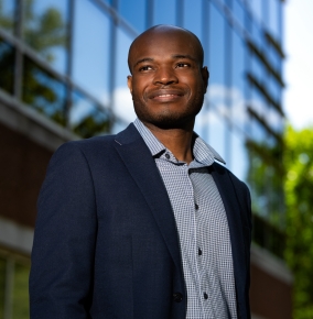 An outdoor portrait photograph of Peter Asuzu.