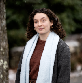 A photo of Madeline McLaughlin outside, with snow lightly falling. 