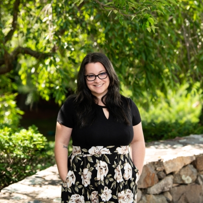 Photo of Corilee Nunes outside with trees in the backround. 