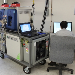 The ultra-sensitive vapor detection system during its first-ever field deployment at Hanscom Air Force Base. Sitting at the operator's station is Ta-Hsuan Ong, staff scientist and technical lead on the project. 