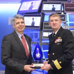 Eric Evans, director of Lincoln Laboratory, left, receives the Aegis Ballistic Missile Defense Pathfinder Award from Rear Admiral Johnny Wolfe.