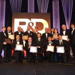 The principal researchers of MIT Lincoln Laboratory's 12 finalists for 2018 R&D 100 Awards are pictured here with Lincoln Laboratory Director Eric Evans (far left). The principal researchers of the 10 winning technologies hold up their award plaques.