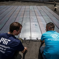 Erik Limpaecher, left, leader of the Energy Systems Group and a co-author on the report, is shown helping to install solar panels for a water purification system at the Boys and Girls Clubs of Puerto Rico in 2017. Photo: Lorenzo Moscia