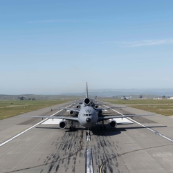 a photo looking of an airplane on an airport runway/ 