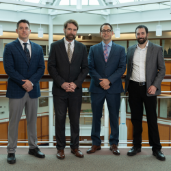 Four leaders representing Air University and Lincoln Laboratory stand for a group photo.
