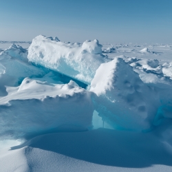 A photo of Arctic sea ice fracturing into big chunks. 