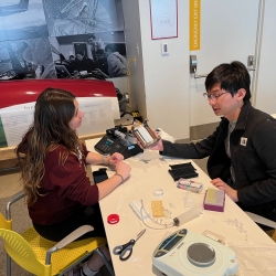 MIT students Rachael Rosco and Brandon Sun work on the droplet-dispensing manifold inside the MIT Lincoln Laboratory Beaver Works center, located on MIT campus.