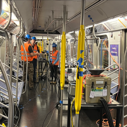 A photo of the study team conducts tests on an NYC subway car. 