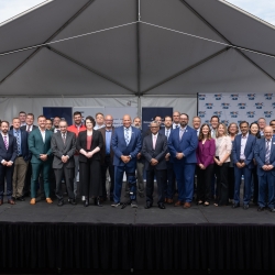 46 individuals pose for a group photo at the NECM Hub funding announcement event.