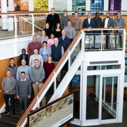 A group of 24 people representing Lincoln Laboratory and students and staff of the Air Command and Staff college pose for a group photo. 