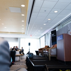 Evelyn Wang, MIT Vice President for Energy and Climate, presents from the a podium at the front of a room of attendees.