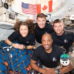 Four astronauts experience zero gravity in space.